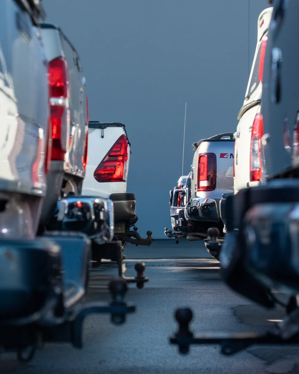 Towbars and tail lights down a row of utes on the NZ Utes lot